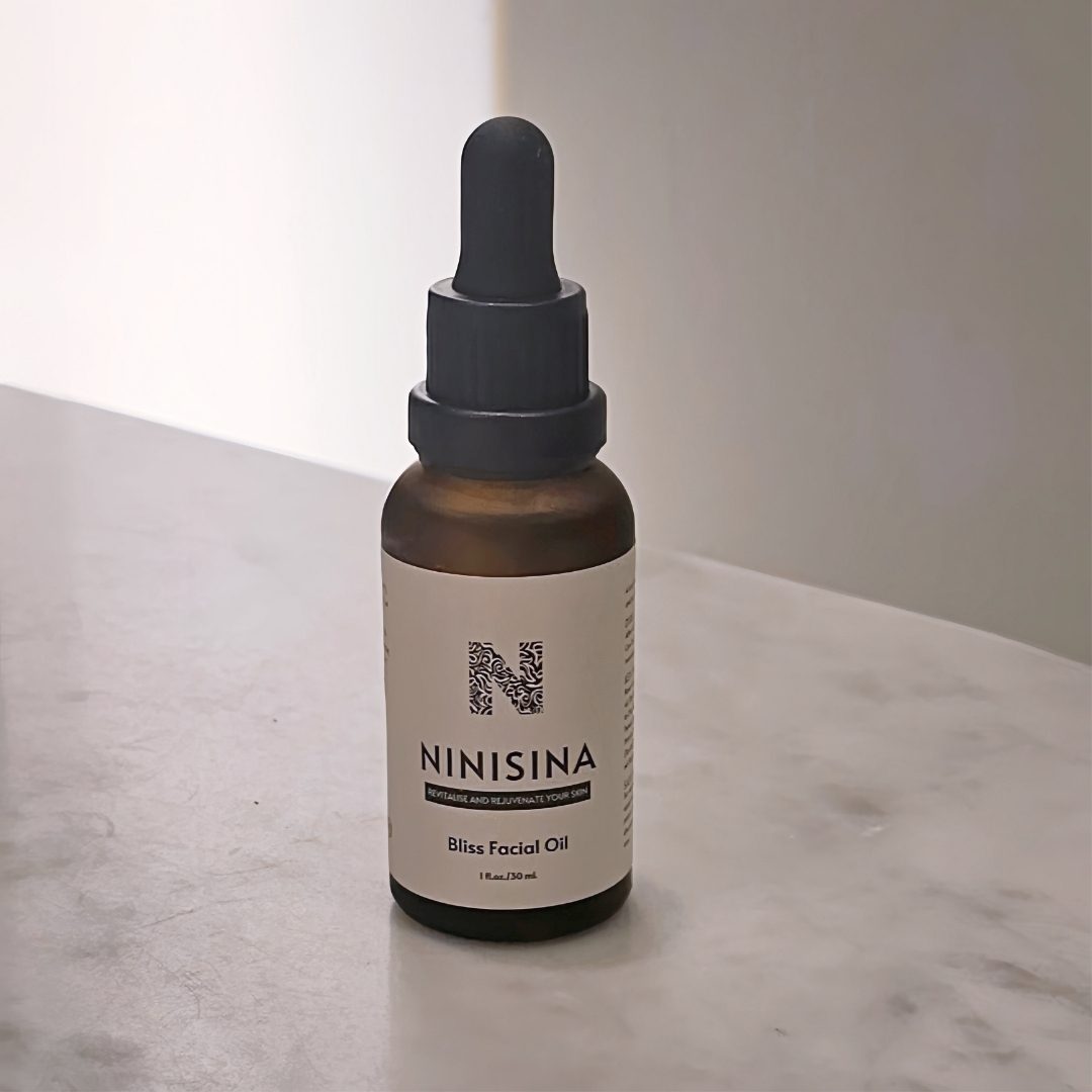 A bottle of Bliss Facial Oil on a pale stone ledge