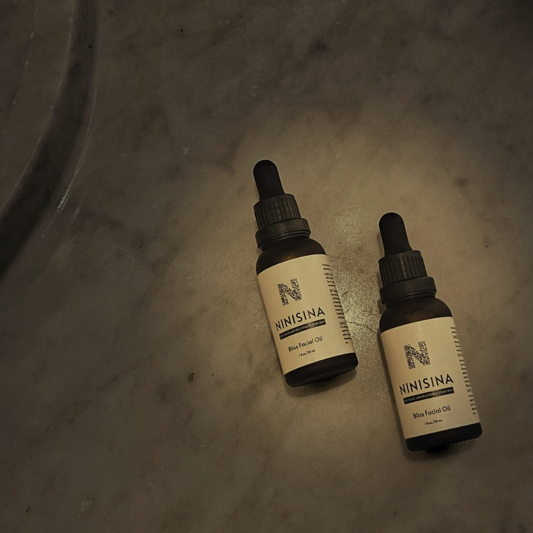 Two sealed bottles on dark marble